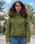 Handmade olive green chunky yarn sweater featuring intricate cable stitches