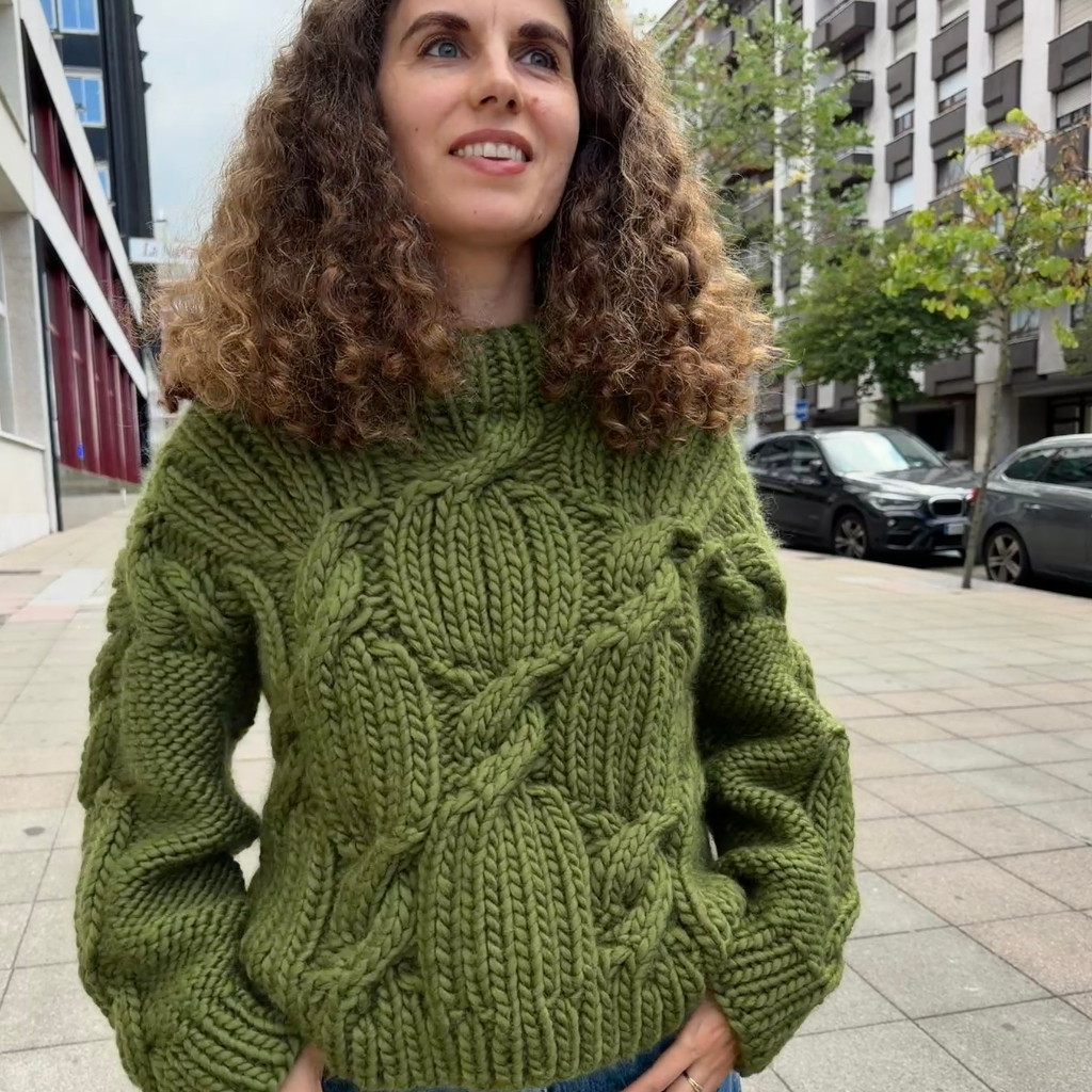 Cozy oversized olive green cable-knit pullover sweater in a street style look